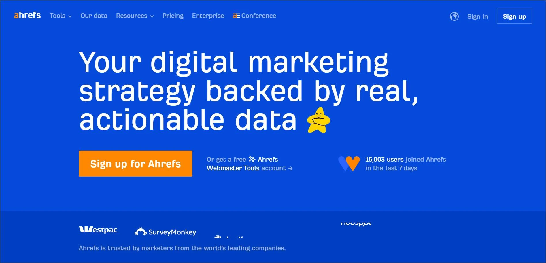 Ahrefs homepage presenting SEO and digital marketing tools with signup button, social proof stats, and partner logos.